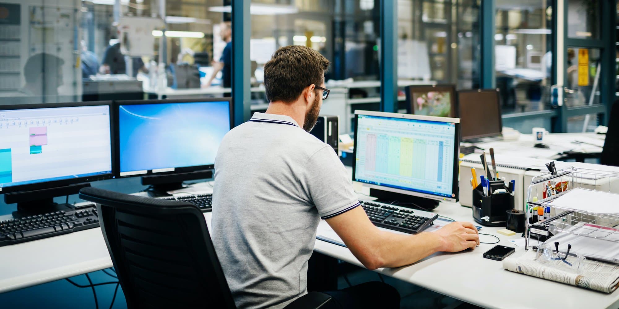 person at desk looking at spreadsheet