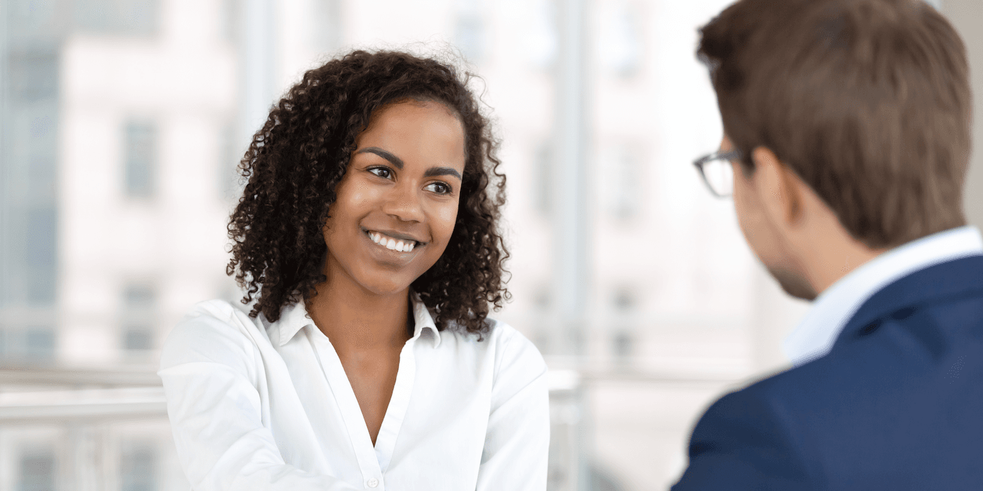 two people sitting across from one another in a job interview