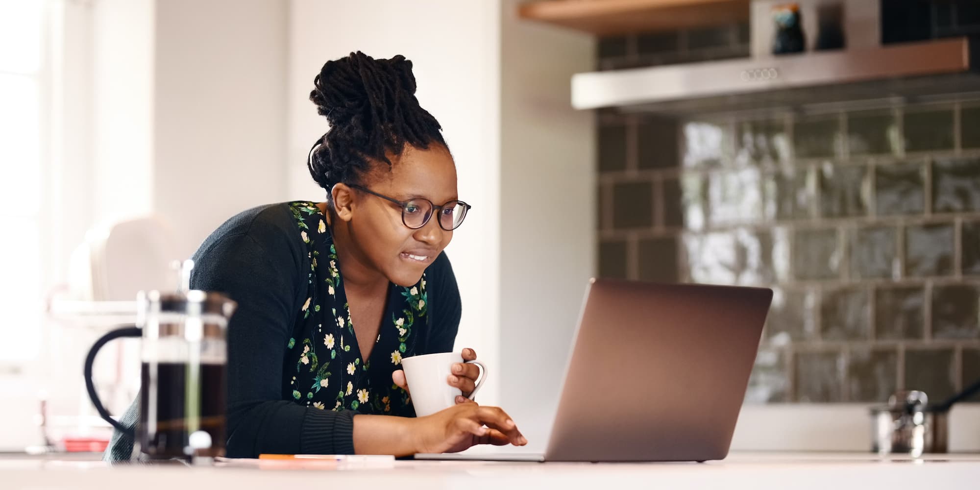 person on laptop drinking coffee