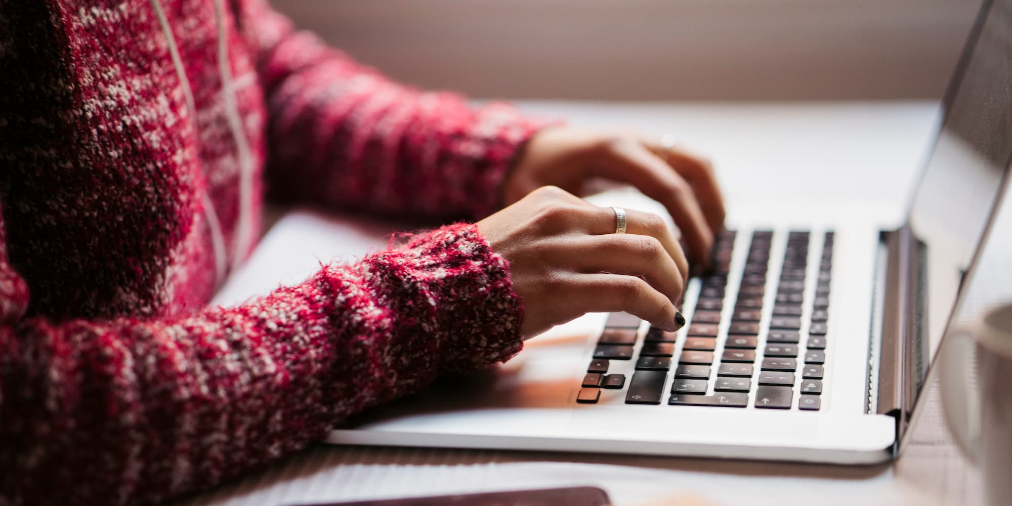 hands typing on a laptop