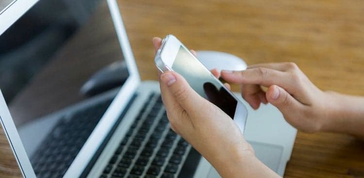 person on phone and computer