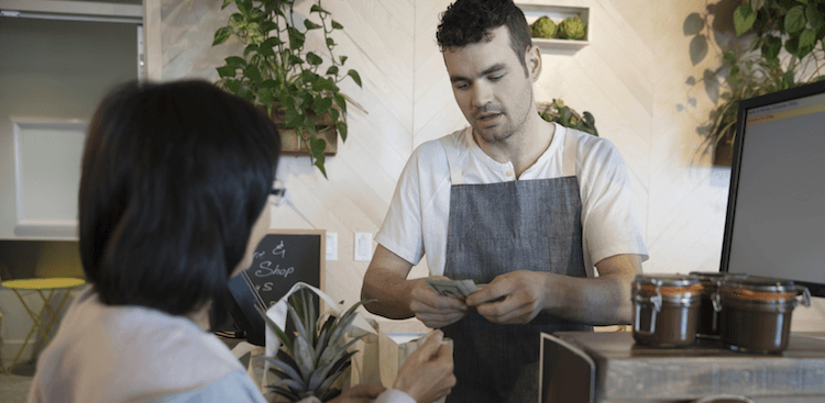 person working at the register of a store