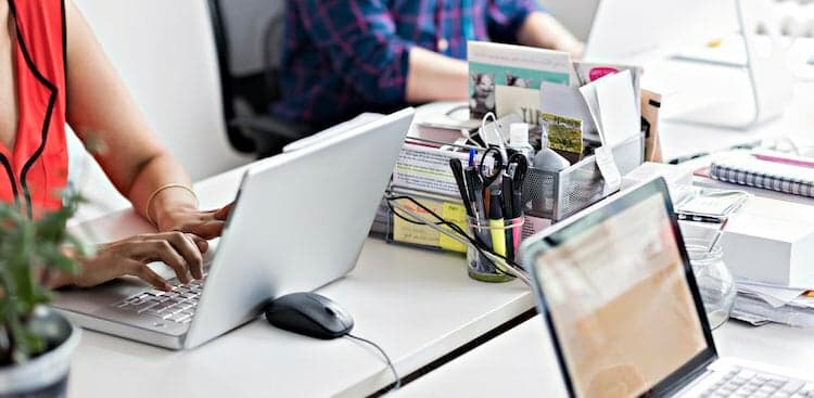 people on laptops in modern office