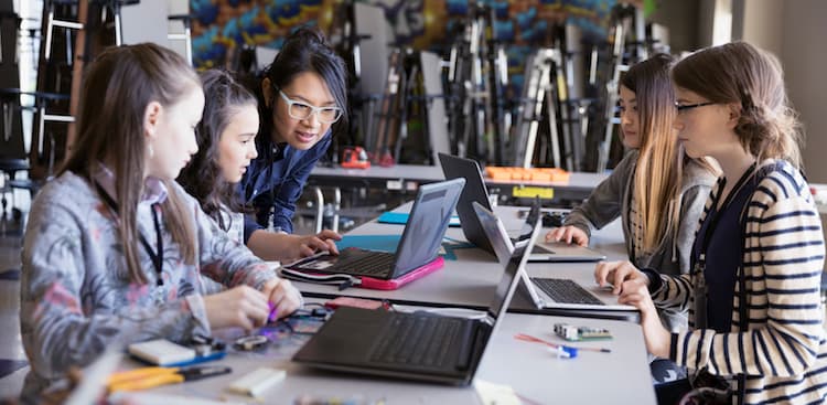 photos of girls at table on laptops