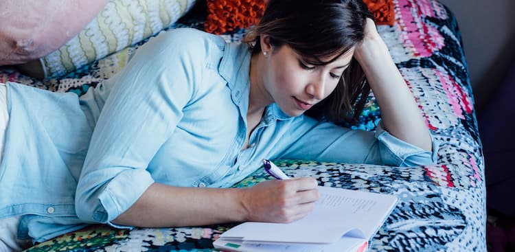 person writing in bed