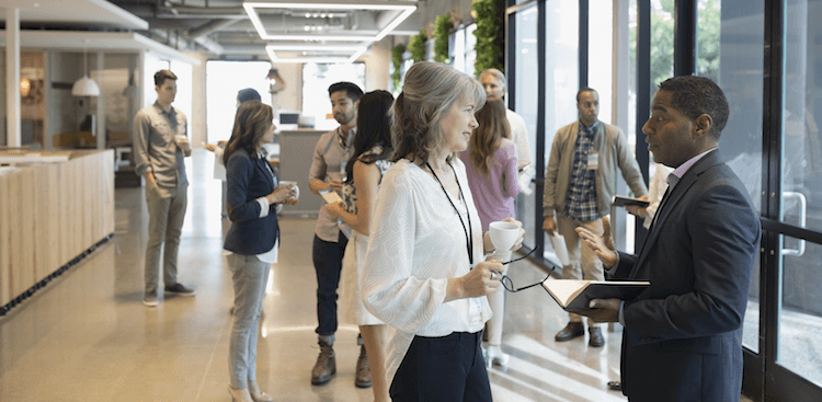 people networking in an office lobby