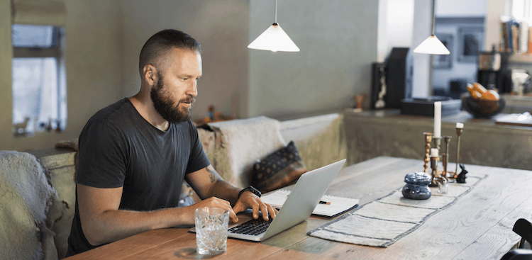 person working at dining table at home