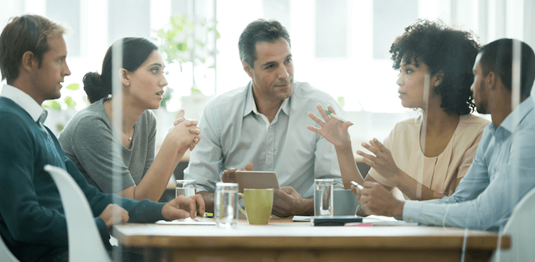 co-workers having a discussion in a conference room