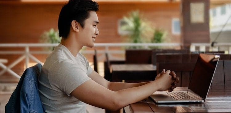 person on computer writing a resume