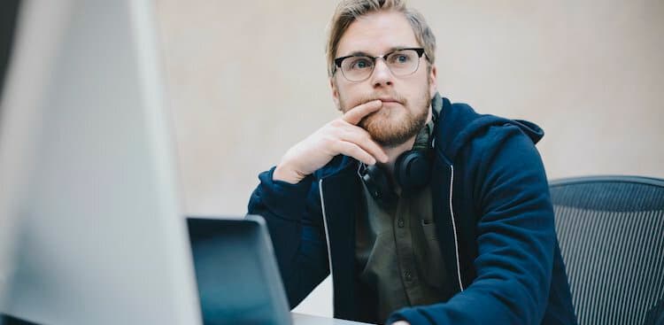 person thinking on computer