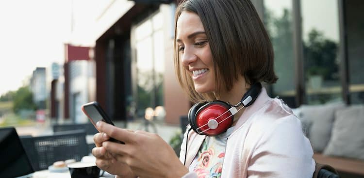 person on phone with headphones