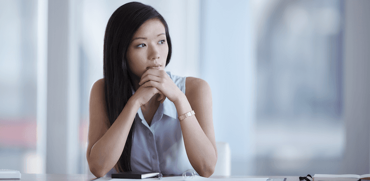 person staring off pensively at work