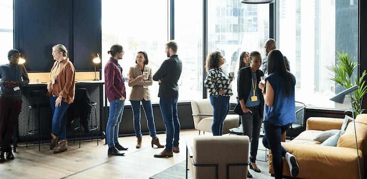 people standing around in an office chatting