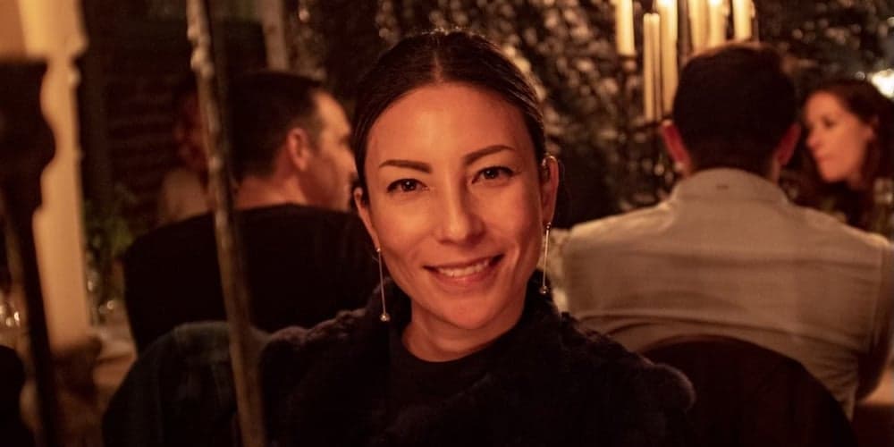 smiling person sitting in a restaurant