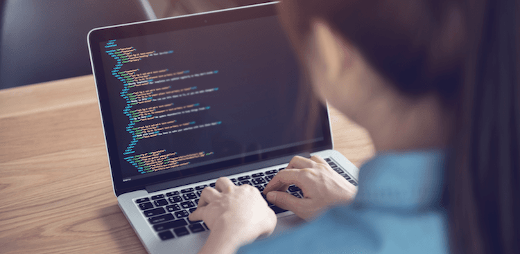 person using a laptop to write code