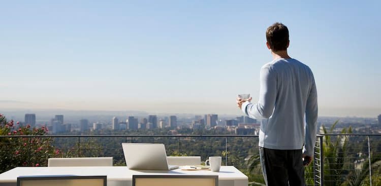 person outside with laptop nearby