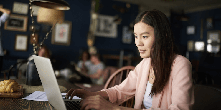 person sitting at a table working on a laptop